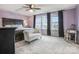 Inviting main bedroom with natural light, dark wood furniture, and a cozy seating area at 17611 Austins Creek Dr, Charlotte, NC 28278