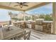 Spacious covered patio features an outdoor kitchen, dining area, and stone countertops at 17611 Austins Creek Dr, Charlotte, NC 28278