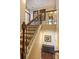 Staircase featuring hardwood steps, iron railings, and neutral wall colors at 17611 Austins Creek Dr, Charlotte, NC 28278