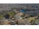 Aerial view of property showcasing a house near a lake and lush trees at 2379 Justin Dr, York, SC 29745