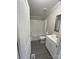 Clean bathroom with white vanity, tub, and grey flooring at 2379 Justin Dr, York, SC 29745