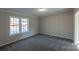 Well-lit bedroom featuring gray carpet and a large window at 2379 Justin Dr, York, SC 29745