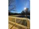 Wooden deck overlooking a sunny backyard with trees and grassy areas at 2379 Justin Dr, York, SC 29745