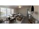 Living room with wood-look floors, large windows, and comfy seating at 2379 Justin Dr, York, SC 29745