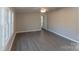 Living room with wood-look floors, large windows, and neutral walls at 2379 Justin Dr, York, SC 29745