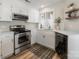 Updated kitchen with white cabinets, stainless steel appliances, and wood flooring at 2719 Selwyn Ave # 11, Charlotte, NC 28209