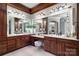 Dual sink vanity and a makeup station are featured in this luxurious bathroom at 3042 Kings Manor Dr, Weddington, NC 28104