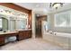 Elegant bathroom with a glass-enclosed shower, soaking tub, and vanity with makeup station at 3042 Kings Manor Dr, Weddington, NC 28104