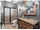 Stylish bathroom with a tiled shower, vanity with decorative mirror, and modern lighting fixtures at 3042 Kings Manor Dr, Weddington, NC 28104