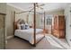 Bedroom showcasing wood furniture, neutral walls, and windows with plantation shutters at 3042 Kings Manor Dr, Weddington, NC 28104