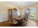 Bright dining room with a chandelier, large windows, hardwood floors, and elegant decor at 3042 Kings Manor Dr, Weddington, NC 28104