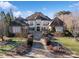 Grand home with manicured landscaping and a welcoming brick walkway to the front entrance at 3042 Kings Manor Dr, Weddington, NC 28104