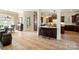 Open-concept kitchen with dark wood cabinetry, granite counters, and a large island with breakfast bar at 3042 Kings Manor Dr, Weddington, NC 28104