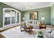 Bright living room with a large arched window, hardwood floors, and neutral decor for a serene atmosphere at 3042 Kings Manor Dr, Weddington, NC 28104