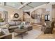Sunlit living room with coffered ceilings, a gray sectional, and access to the foyer and staircase at 3042 Kings Manor Dr, Weddington, NC 28104