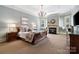 Spacious main bedroom suite features a cozy fireplace, tray ceiling, and ample natural light at 3042 Kings Manor Dr, Weddington, NC 28104