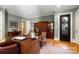 Home office with custom built-ins, a large desk, and a decorative glass front door at 3042 Kings Manor Dr, Weddington, NC 28104