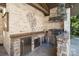 Elegant outdoor kitchen featuring stainless steel appliances and stone counters, perfect for entertaining at 3042 Kings Manor Dr, Weddington, NC 28104