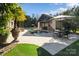 Stunning outdoor pool area with a covered lounge, elegant seating, and fire pit, ideal for relaxation at 3042 Kings Manor Dr, Weddington, NC 28104
