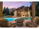 Relaxing poolside view with outdoor kitchen and string lights at 3042 Kings Manor Dr, Weddington, NC 28104