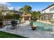 Beautiful pool area with an outdoor kitchen, fire pit, basketball court, and elegant seating for entertaining at 3042 Kings Manor Dr, Weddington, NC 28104