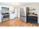 This kitchen features stainless steel appliances, white cabinets, and hardwood floors at 364 Scotts Creek Rd, Statesville, NC 28625