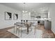 Eat-in kitchen featuring a large island, modern appliances, and a dining area with contemporary decor at 5215 Hatcher Creek Rd # 40, Charlotte, NC 28215