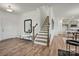 Bright entryway featuring wood floors, stairs to the second floor, and a stylish mirror and bench at 5215 Hatcher Creek Rd # 40, Charlotte, NC 28215