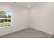 Well-lit bedroom with window and neutral carpeting at 5240 Carden Dr, Charlotte, NC 28227