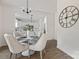 Elegant dining room features a round table, four chairs, and a large clock at 5240 Carden Dr, Charlotte, NC 28227