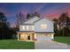 Two-story white house with a brick base, two-car garage, and landscaped lawn at 5240 Carden Dr, Charlotte, NC 28227