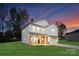 Two-story white house with a brick base, two-car garage, and landscaped lawn at 5240 Carden Dr, Charlotte, NC 28227