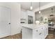 White kitchen with island, stainless steel appliances, and hardwood floors at 5240 Carden Dr, Charlotte, NC 28227