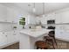 Modern white kitchen with an island, stainless steel appliances, and hardwood floors at 5240 Carden Dr, Charlotte, NC 28227