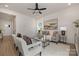 Living room with a neutral color scheme, comfortable seating, and access to hallway at 5240 Carden Dr, Charlotte, NC 28227