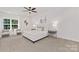 Spacious main bedroom with plush carpeting, a king-size bed, and a ceiling fan at 5240 Carden Dr, Charlotte, NC 28227