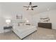 Main bedroom with king bed, neutral tones, and ceiling fan at 5240 Carden Dr, Charlotte, NC 28227