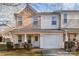Two-story townhome with neutral siding, attached garage, and small front porch at 5927 Pisgah Way, Charlotte, NC 28217