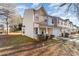Tan and brown two-story townhome with a brick porch and landscaping at 5927 Pisgah Way, Charlotte, NC 28217