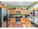 Kitchen with wood cabinets, stainless steel appliances, and green walls at 5927 Pisgah Way, Charlotte, NC 28217