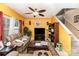 Bright yellow living room with two sofas, a TV, and a ceiling fan at 5927 Pisgah Way, Charlotte, NC 28217