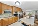 Kitchen boasts wood cabinets, stainless steel appliances, and granite counters at 103 Greendale Dr, Mount Holly, NC 28120