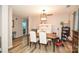 Dining room with wooden table and chairs, view into living room and kitchen at 11677 Striker Ln, Midland, NC 28107