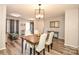 Elegant dining room with modern light fixture, stylish chairs, and sleek wood floors at 11677 Striker Ln, Midland, NC 28107