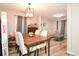 Dining room with wooden table and chairs, and view into living room at 11677 Striker Ln, Midland, NC 28107