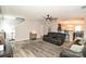 Open living area with wood floors, a ceiling fan, and a view of the staircase at 11677 Striker Ln, Midland, NC 28107