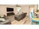 Comfortable living room featuring wood floors, a ceiling fan, and a view to the staircase at 11677 Striker Ln, Midland, NC 28107
