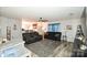 Living room with gray sectional sofa and ceiling fan at 11677 Striker Ln, Midland, NC 28107