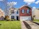 Two-story brick home with a spacious yard and two-car driveway at 14035 Lawrence Farm Ln, Charlotte, NC 28278