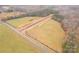 Overhead view of the new road construction surrounded by open fields and wooded areas at 1502 Baileys Run, Gastonia, NC 28056